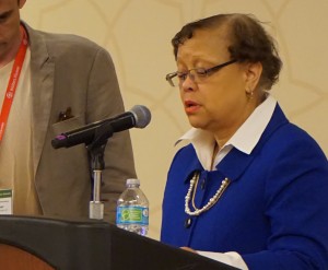 Patricia Lee behind a podium