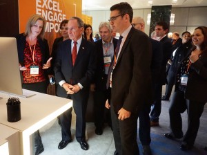 Former Mayor of New York City Michael Bloomberg standing with team from Bloomberg Law at the 2016 Annual Meeting Opening Reception in front of computer.