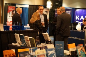 Group of attendees standing and talking in the 2016 AALS Exhibit Hall