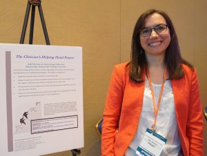 Katy Ramsey, The George Washington University Law School, standing next to poster for the Clinician's Helping Hand Project